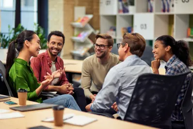 Group of people sitting together, having a friendly discussion